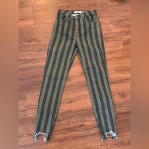 Green and dark grey/black striped skinny jeans with distress.